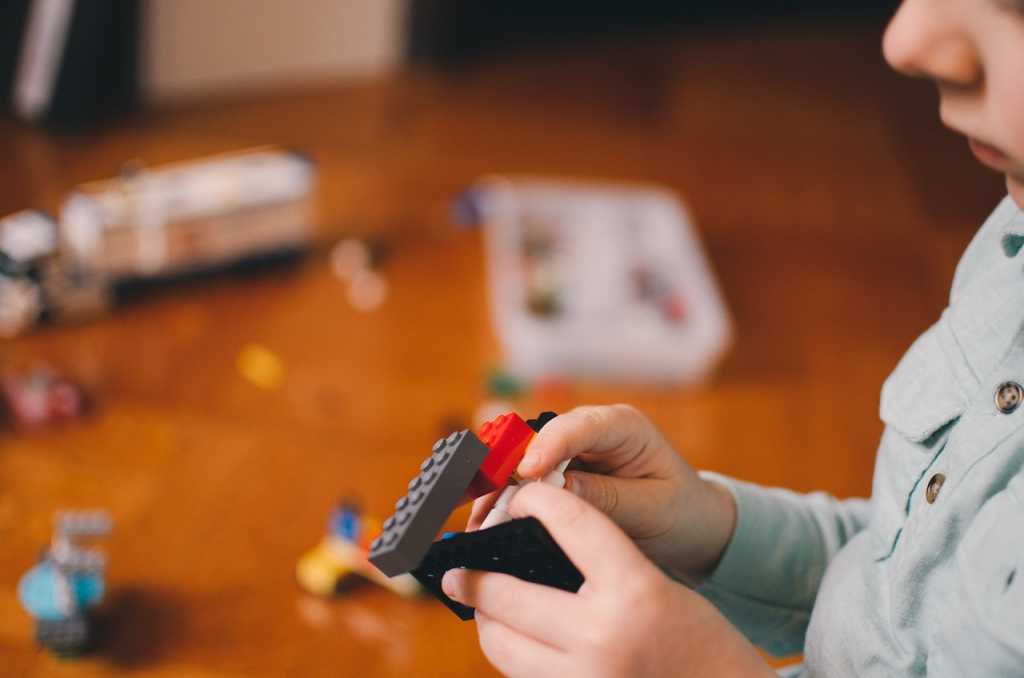Child playing with lego bricks